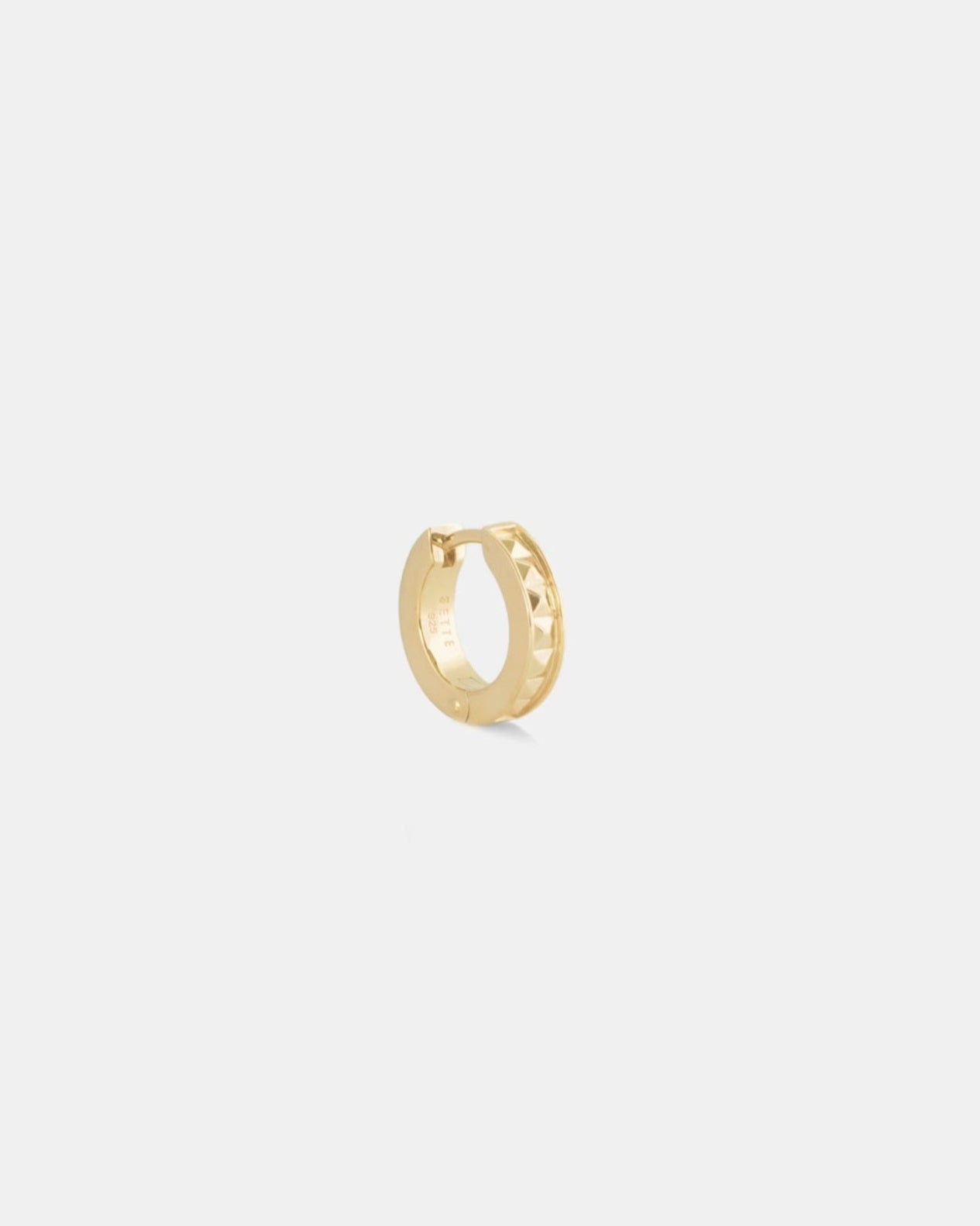 small gold hoop huggie with stud detail on white background by studio sette