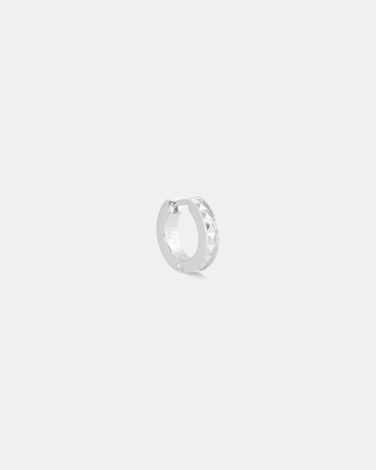 silver hoop huggie with studs on white background by studio sette