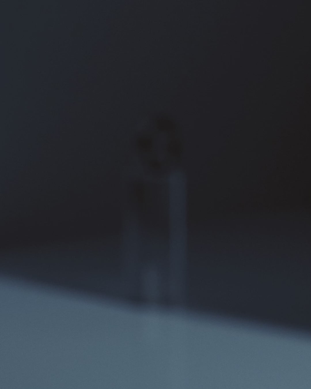 light slowly revealing black band ring on clear podium