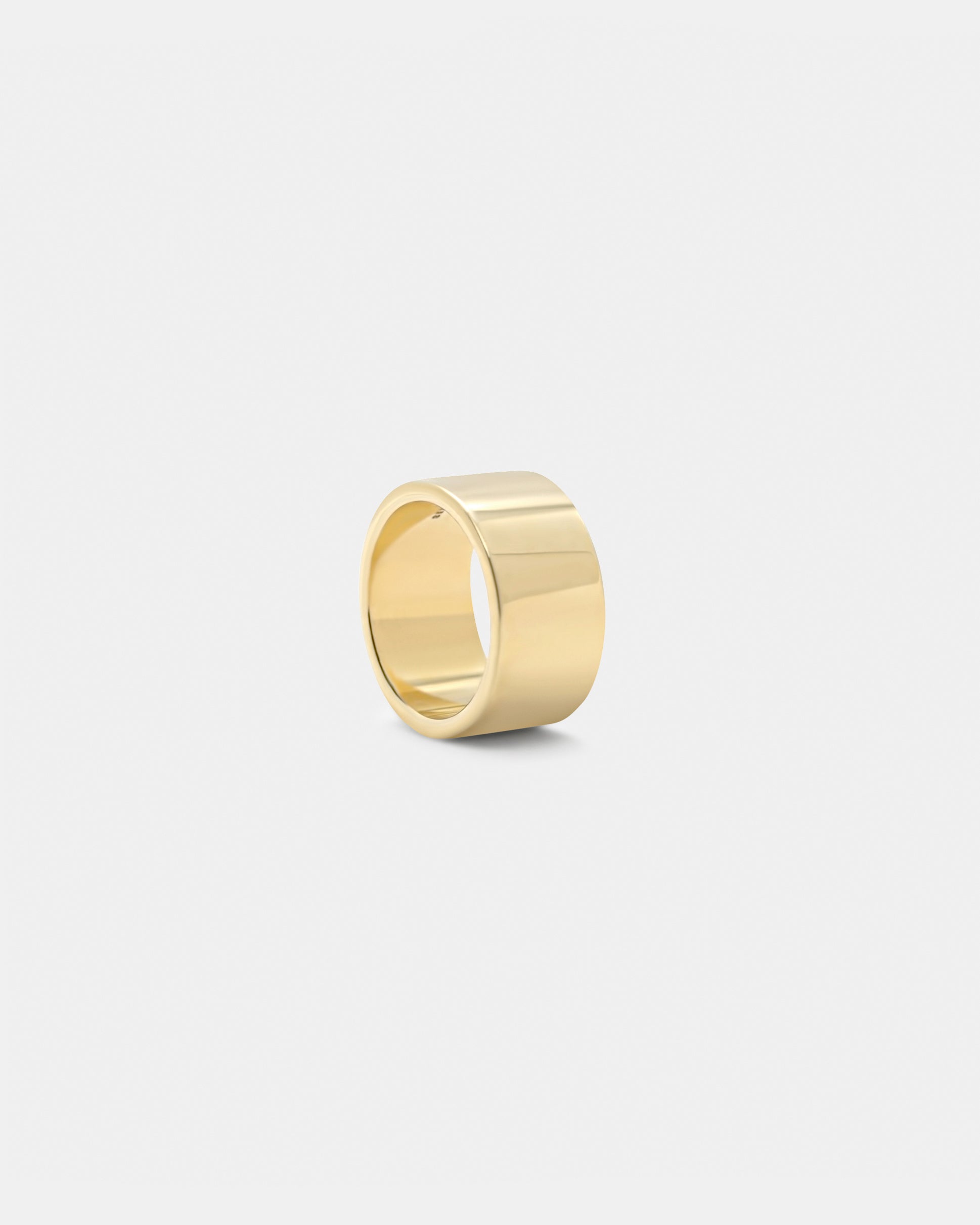 A gold polished ring with a simple and elegant design, displayed against a white background by studio sette