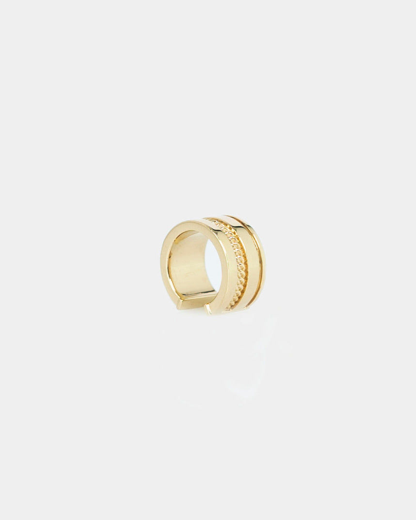 sleek gold ear cuff with chain detail on white background by studio sette