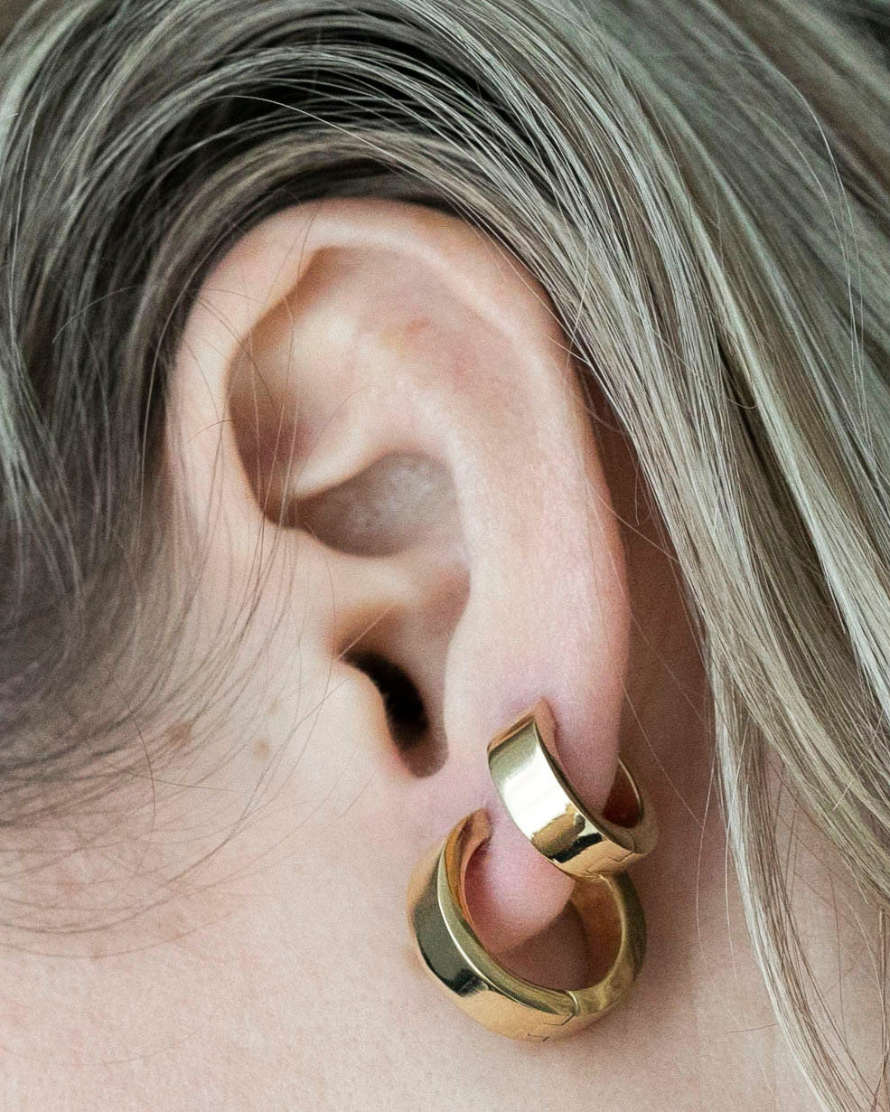 small and medium hoops earrings closeup on ear blonde hair