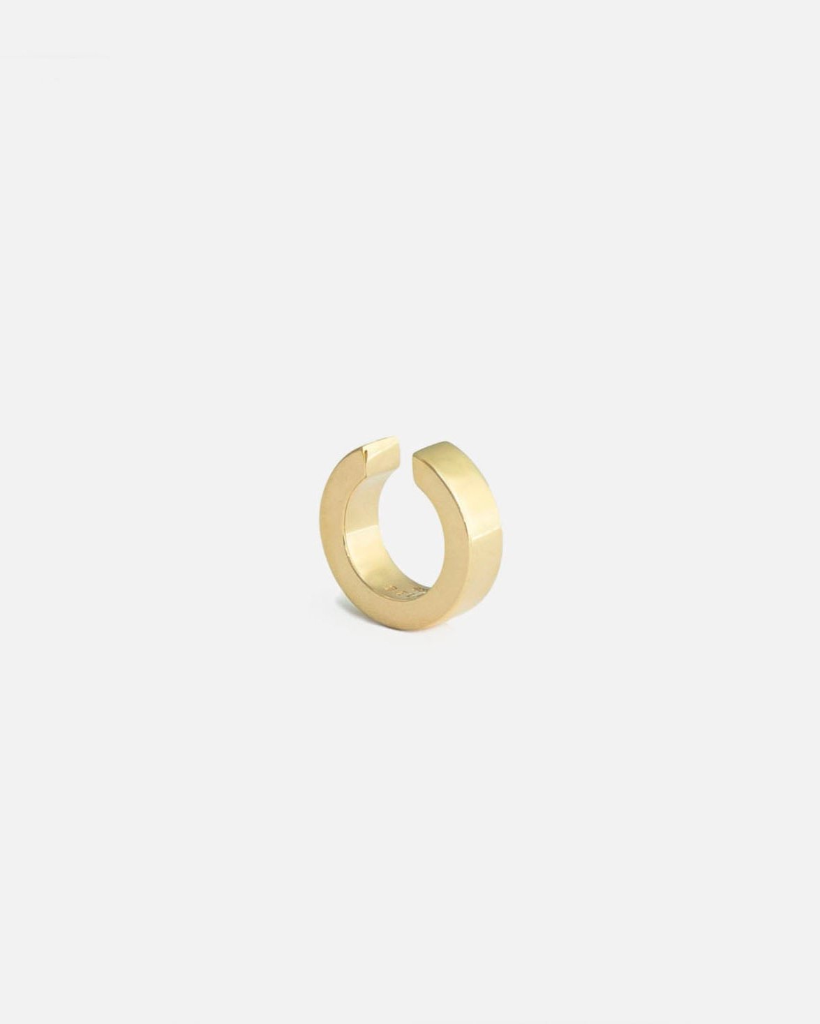 gold ear cuff on white background by studio sette