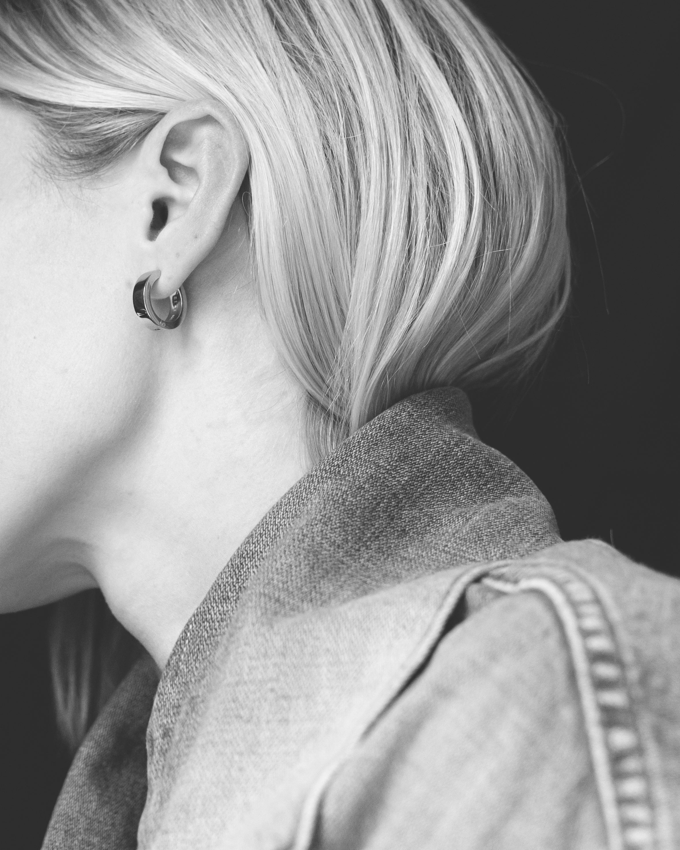 unisex polished silver hoop on model wearing denim jacket with blonde hair in monochrome