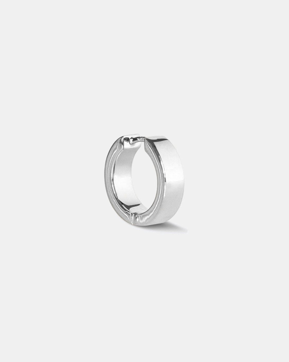polished silver hoop earring on white background by studio sette