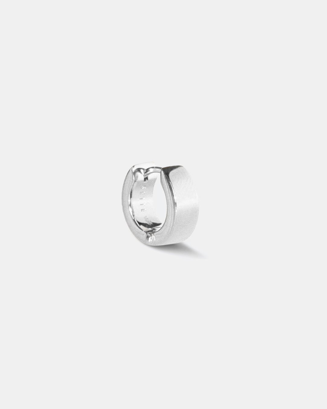 small single silver polished hoop earring with a white rhodium plating, on a white background by studio sette