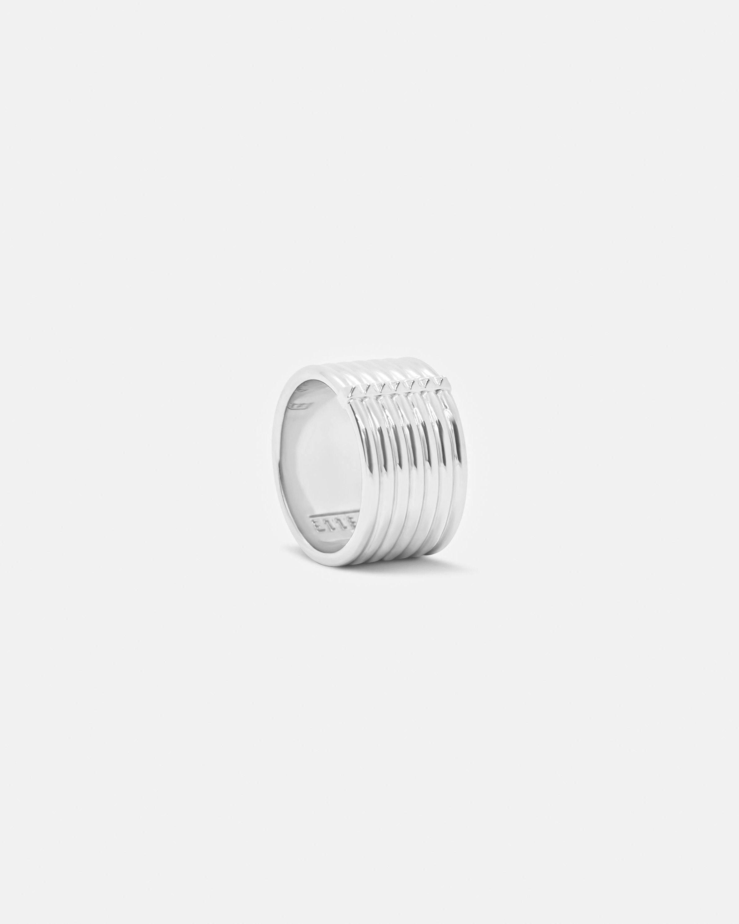 chunky band ring with pyramid stud detailing on white background by studio sette