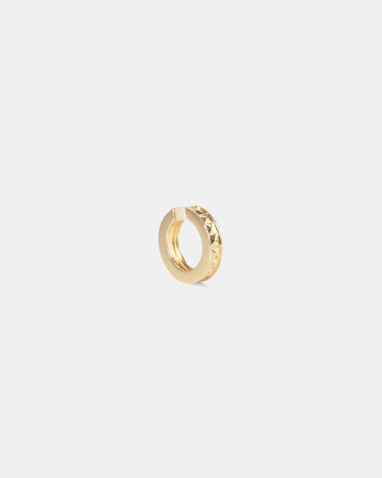 Gold studded ear cuff on white background by studio sette