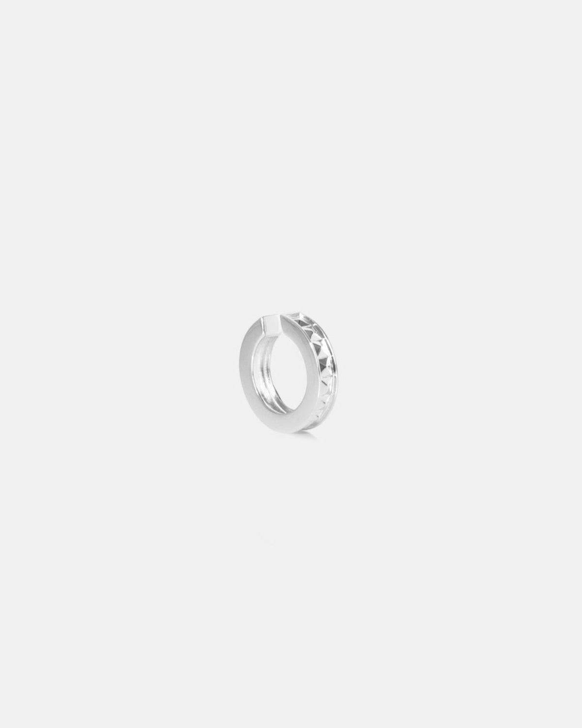 studded silver ear cuff on white background by studio sette