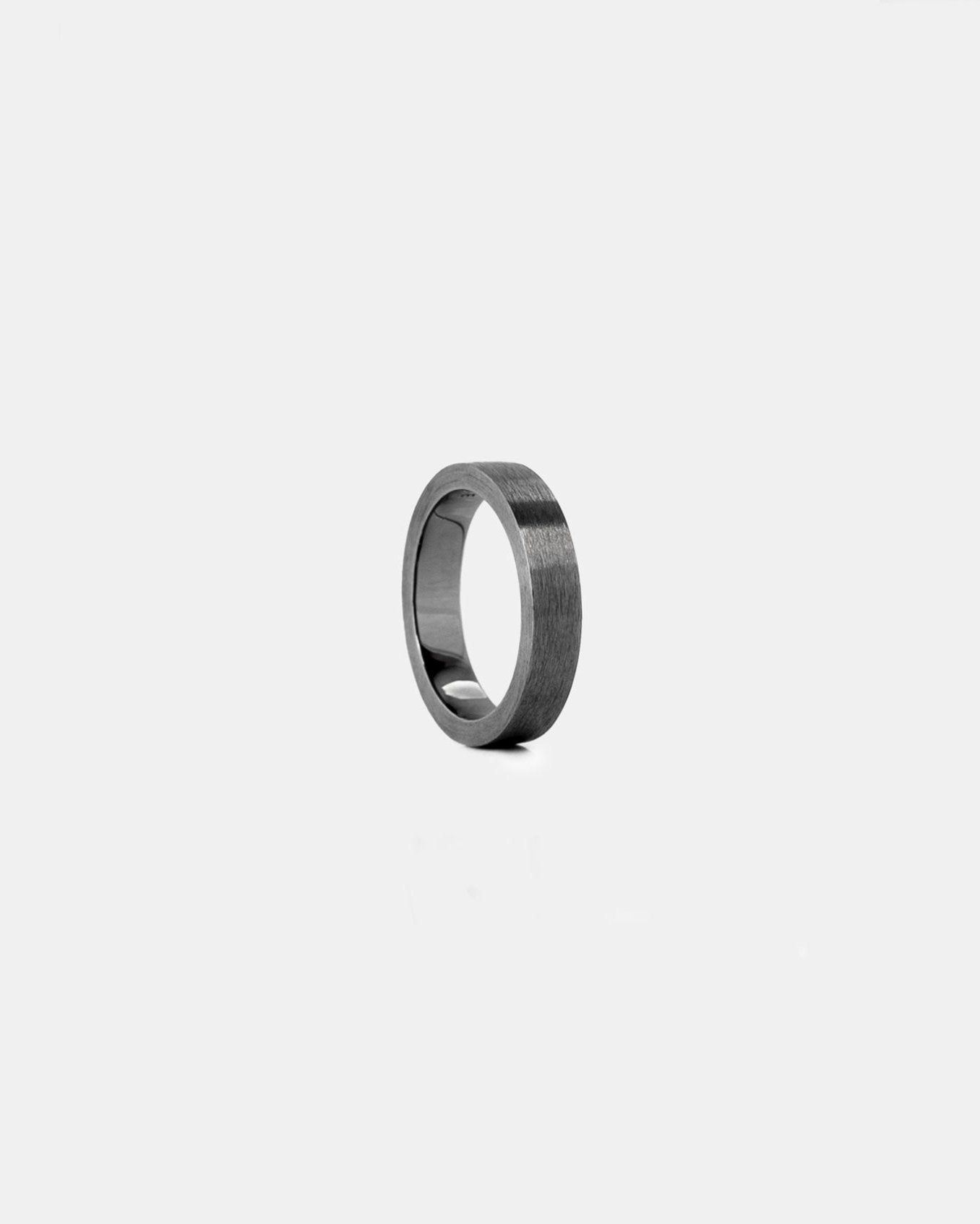 studio sette simple thick black band ring brushed effect on white background