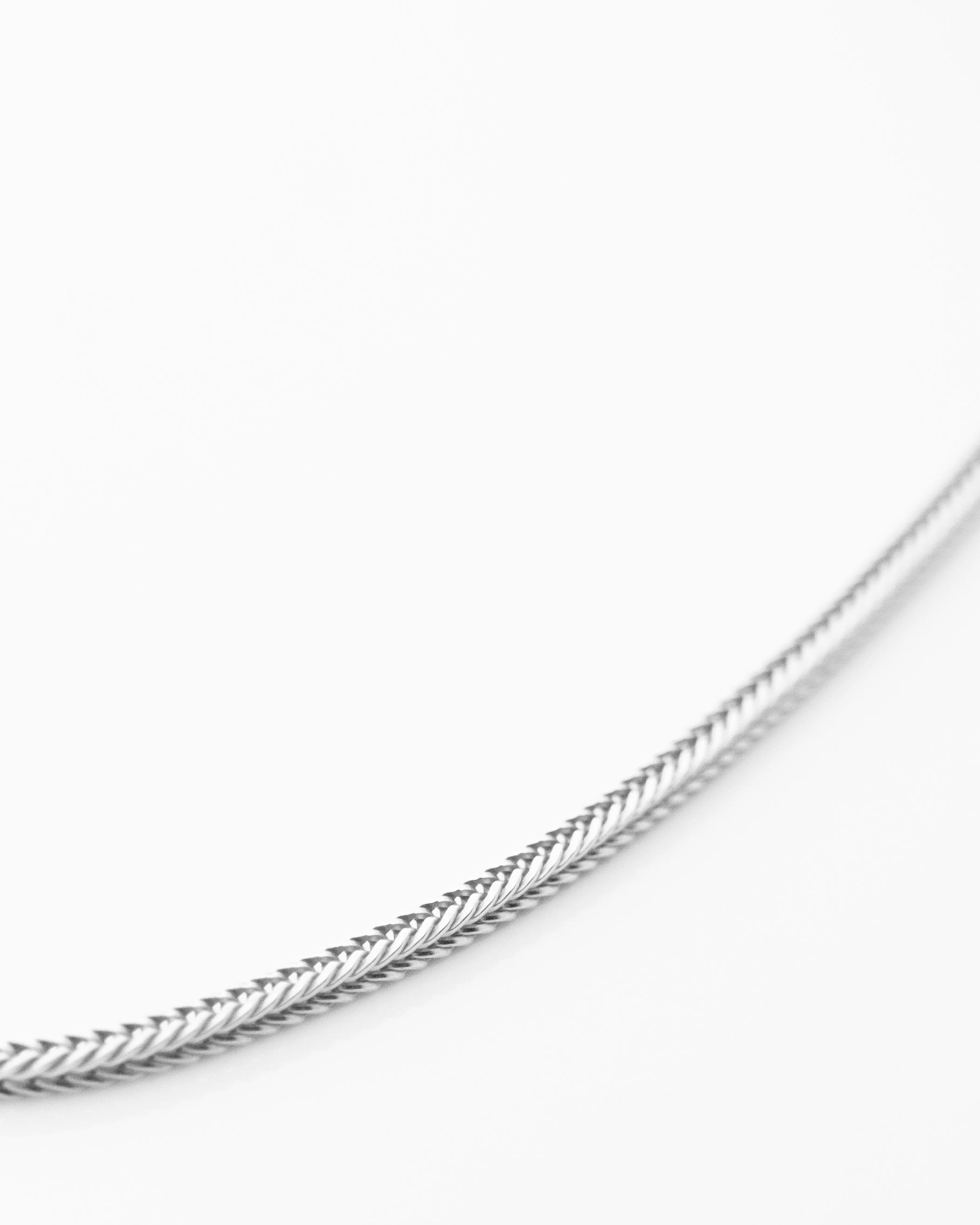 silver fox chain closeup displayed on white background
